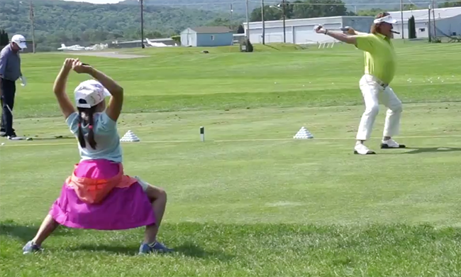 Young fan mimics Miguel Angel Jimenez' warmup routine with him